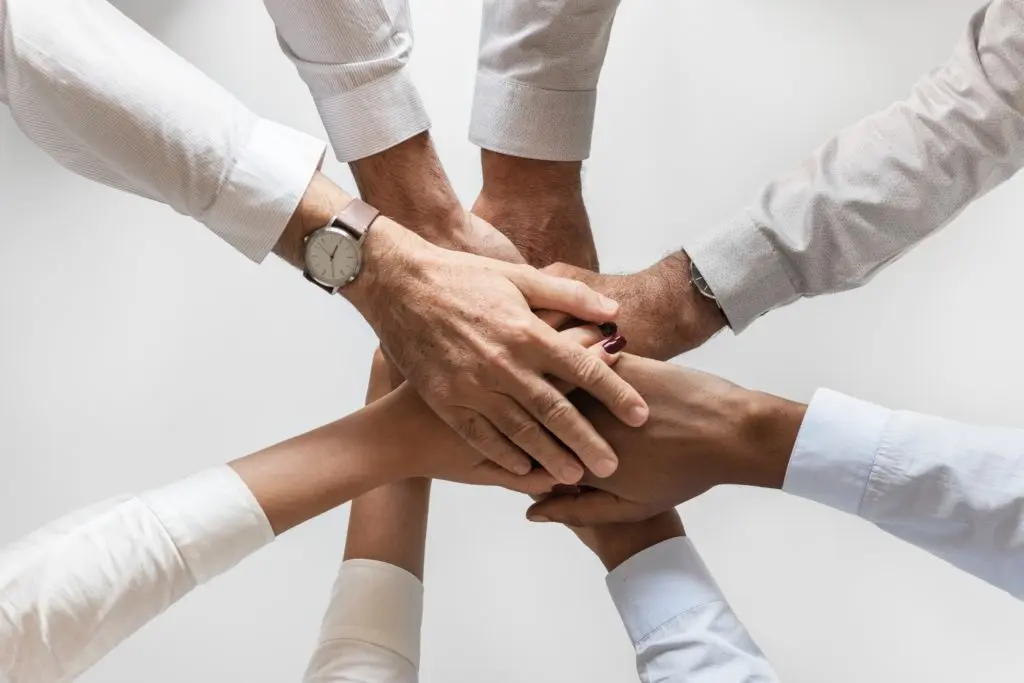 Team of 8 hands stacked together
