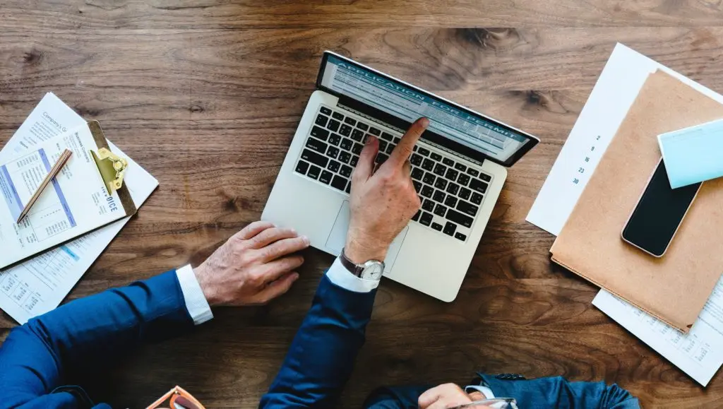 Male hands pointing at laptop screen having a meeting